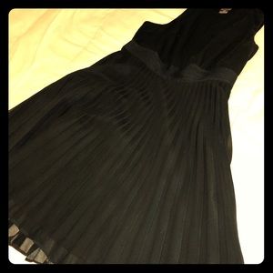 Black dress with pleated skirt.
